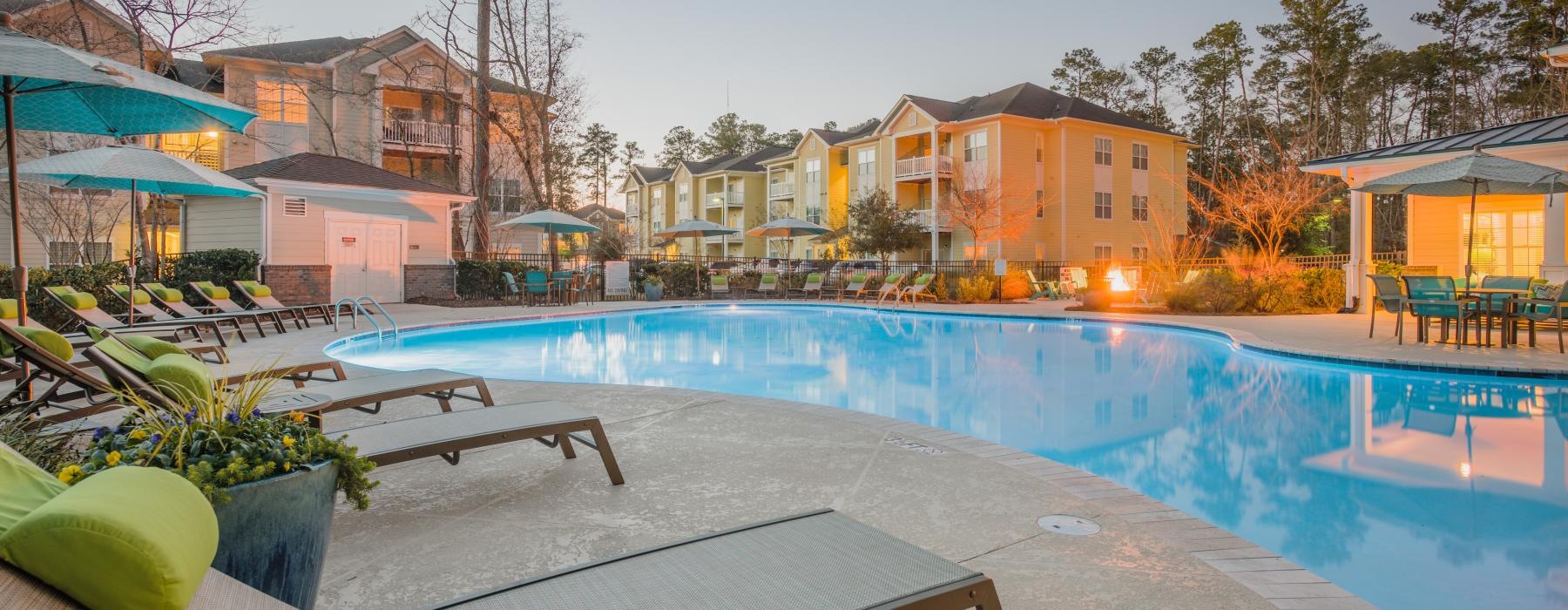 a pool with a bench and a lounge chair by it